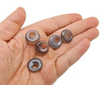 Grey agate crystal donut pendant from GemstoneGO, 18mm Pi stone with polished surface and unique natural banding.