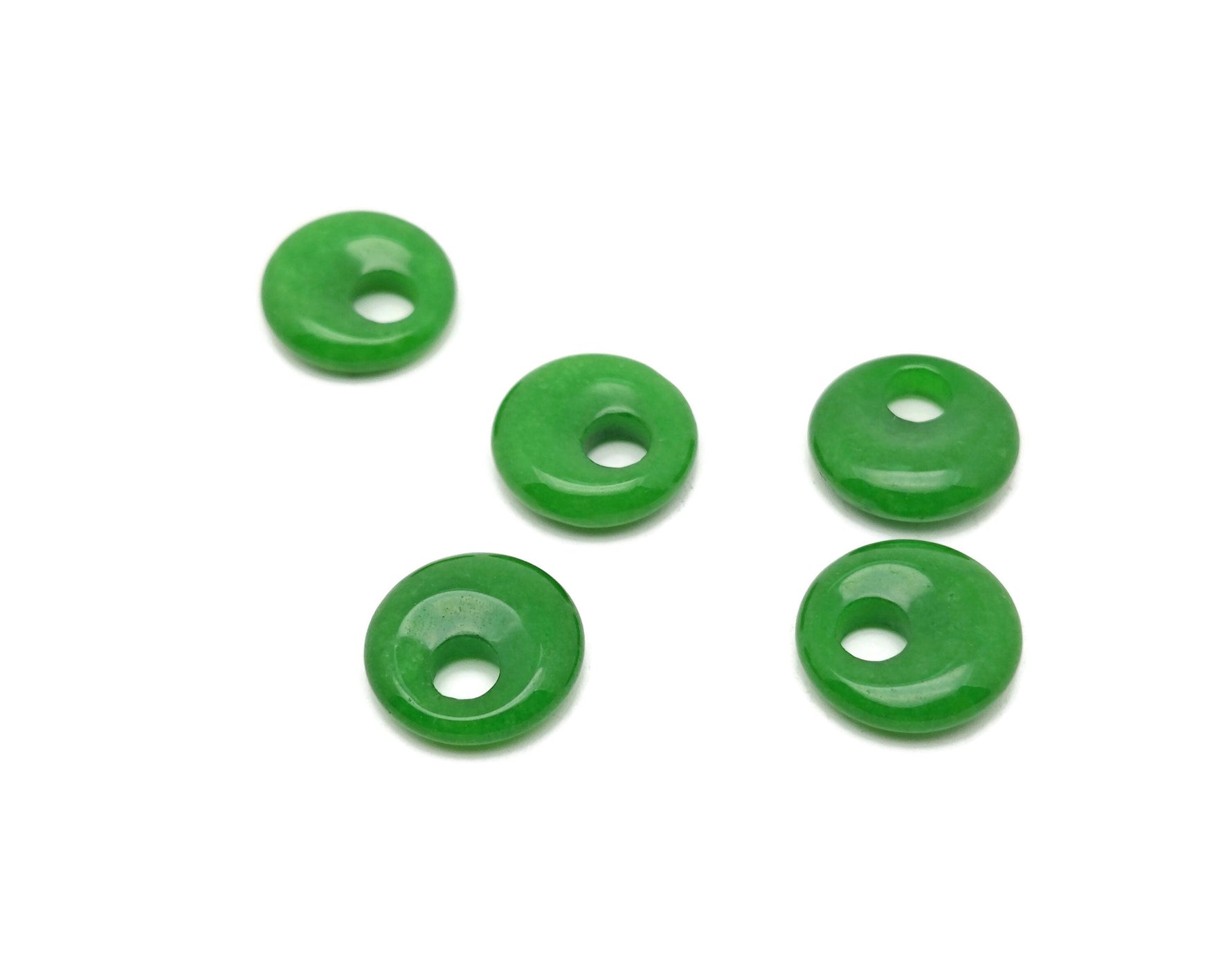 Green Jade crystal donut pendant, 18mm Pi stone by GemstoneGO, showcasing a smooth, polished green jade gemstone with a circular shape.