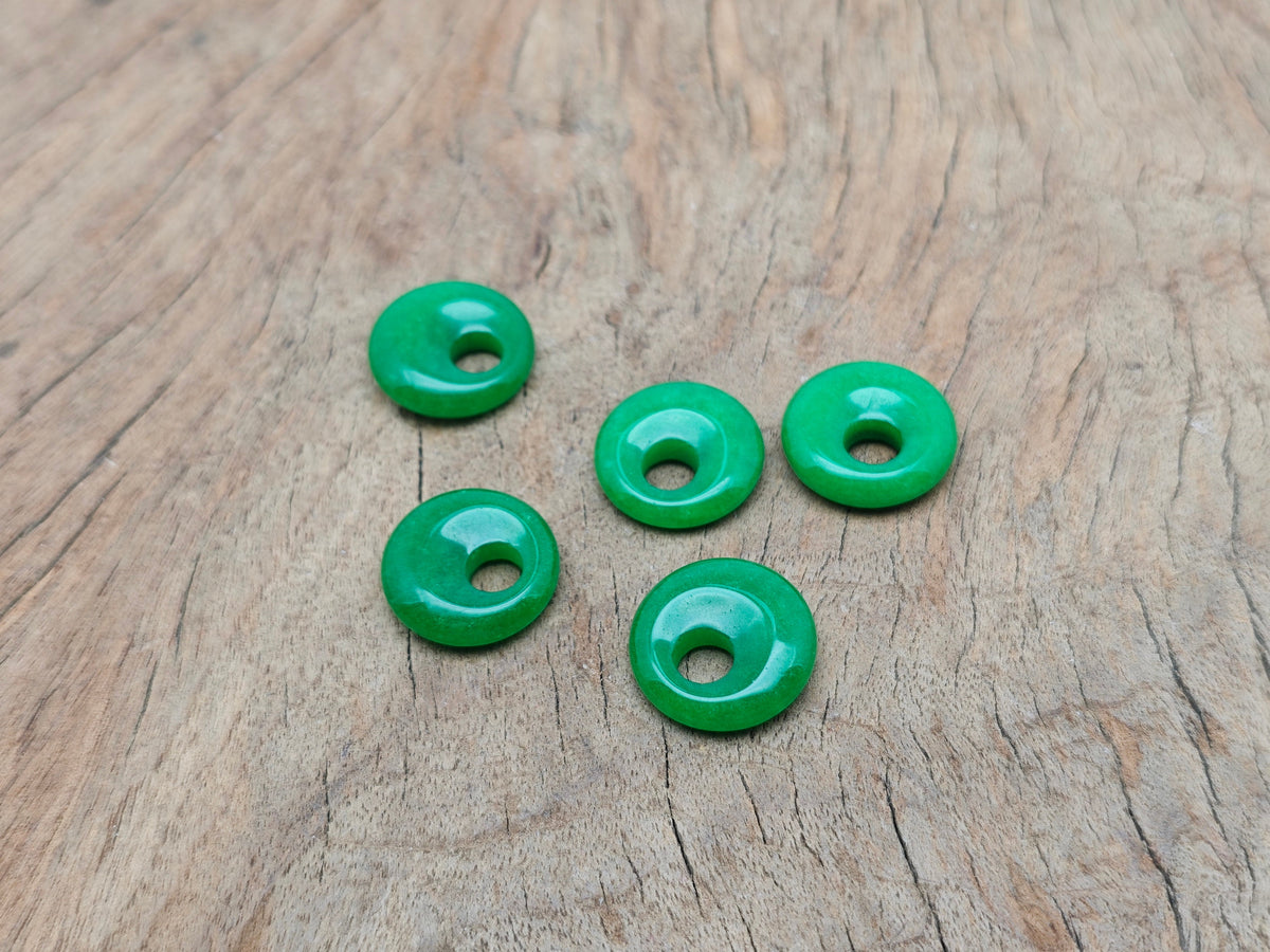 Green Jade crystal donut from GemstoneGO, 18mm Pi Stone with smooth polished surface and vibrant green color.