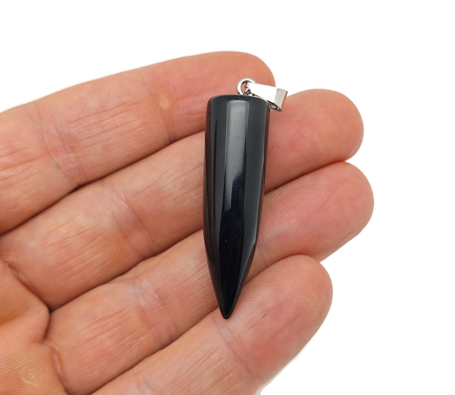 Polished obsidian bullet gemstone pendant with carved details, showcasing a smooth black stone on a jewelry chain.