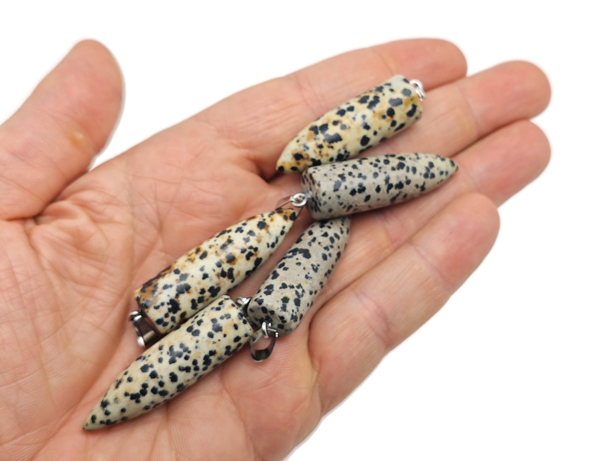 Dalmatian Jasper Bullet Pendant by GemstoneGO featuring a polished, carved gemstone bullet pendant with distinctive black and cream spots.