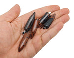 Polished mahogany obsidian bullet gemstone pendant with carved details, showcasing a smooth, natural black and reddish-brown stone.