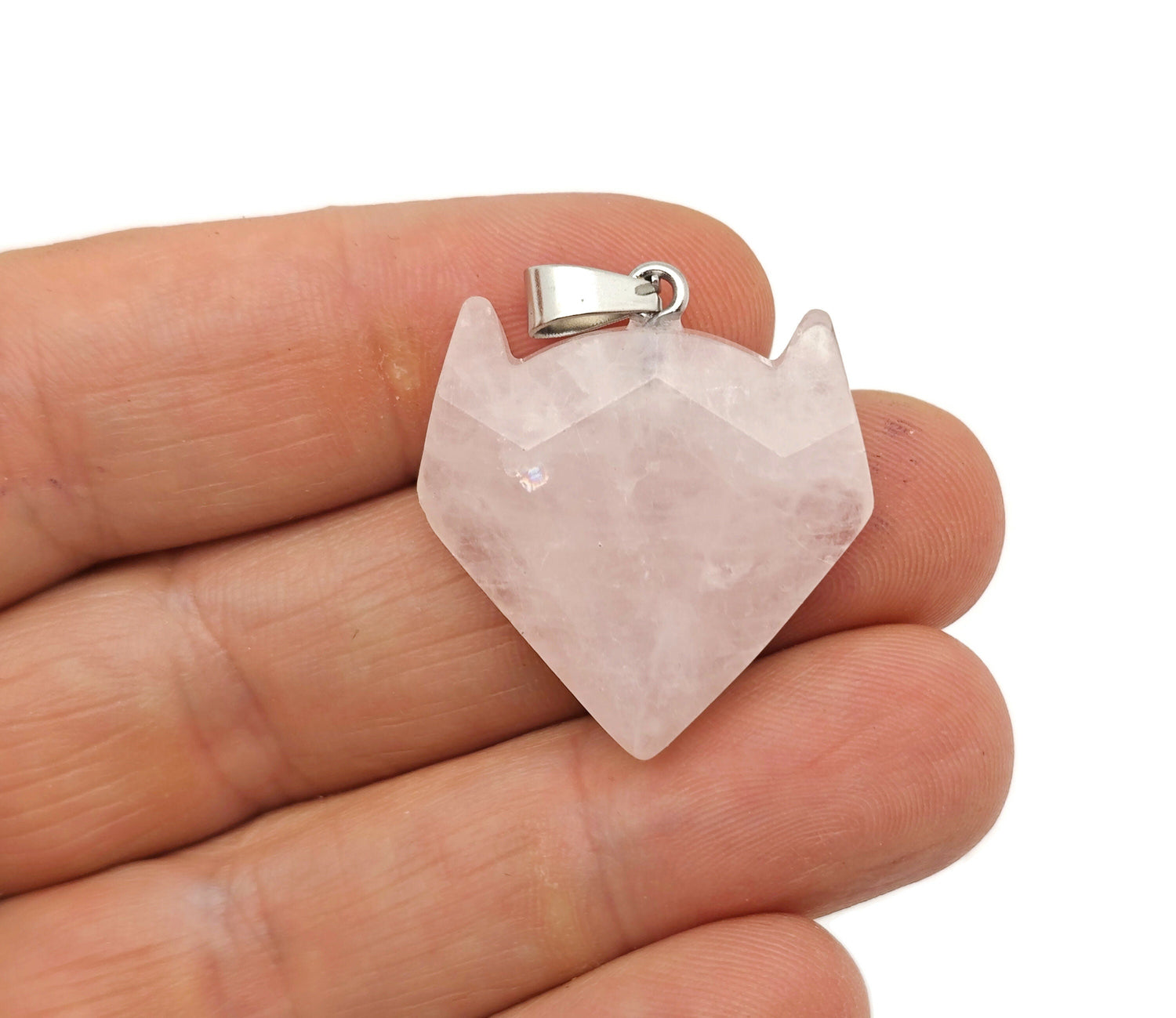 Rose quartz wolf head gemstone pendant from GemstoneGO featuring a crystal jewelry design with pink stone and intricate wolf motif.