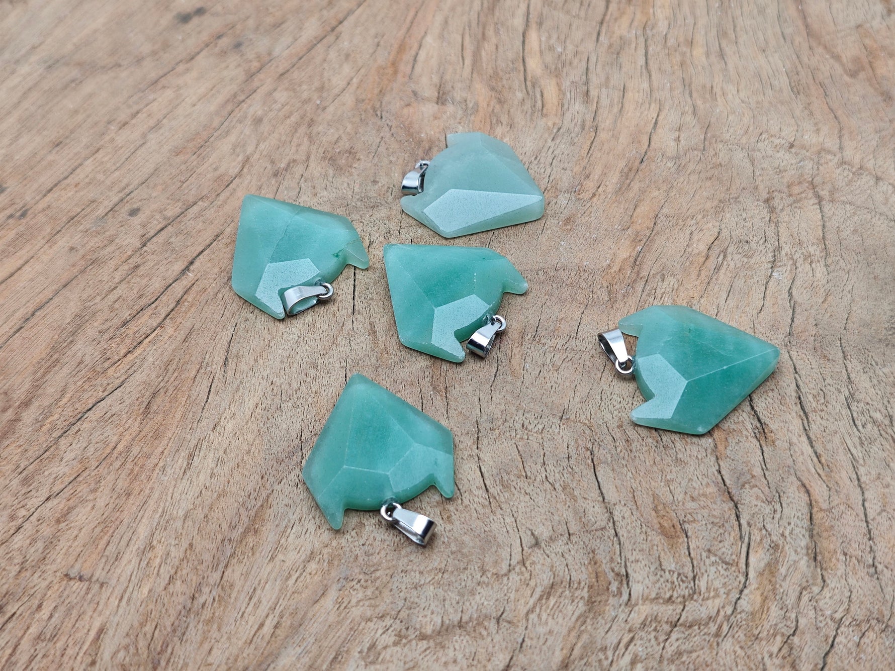 Aventurine wolf head gemstone pendant from GemstoneGO, featuring detailed carved crystal jewelry with a natural green hue.