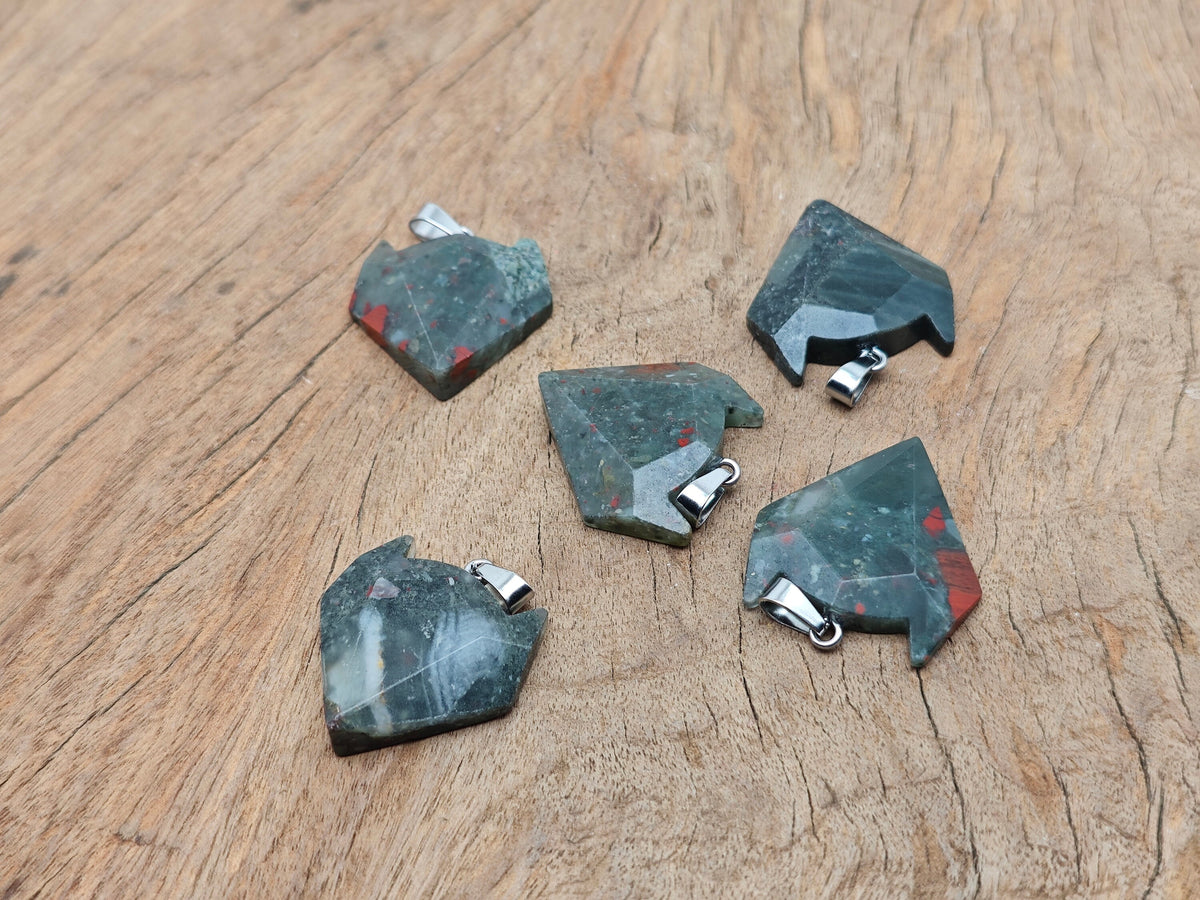 African Bloodstone wolf head gemstone pendant featuring a carved wolf design in vibrant bloodstone, perfect for crystal jewelry enthusiasts.