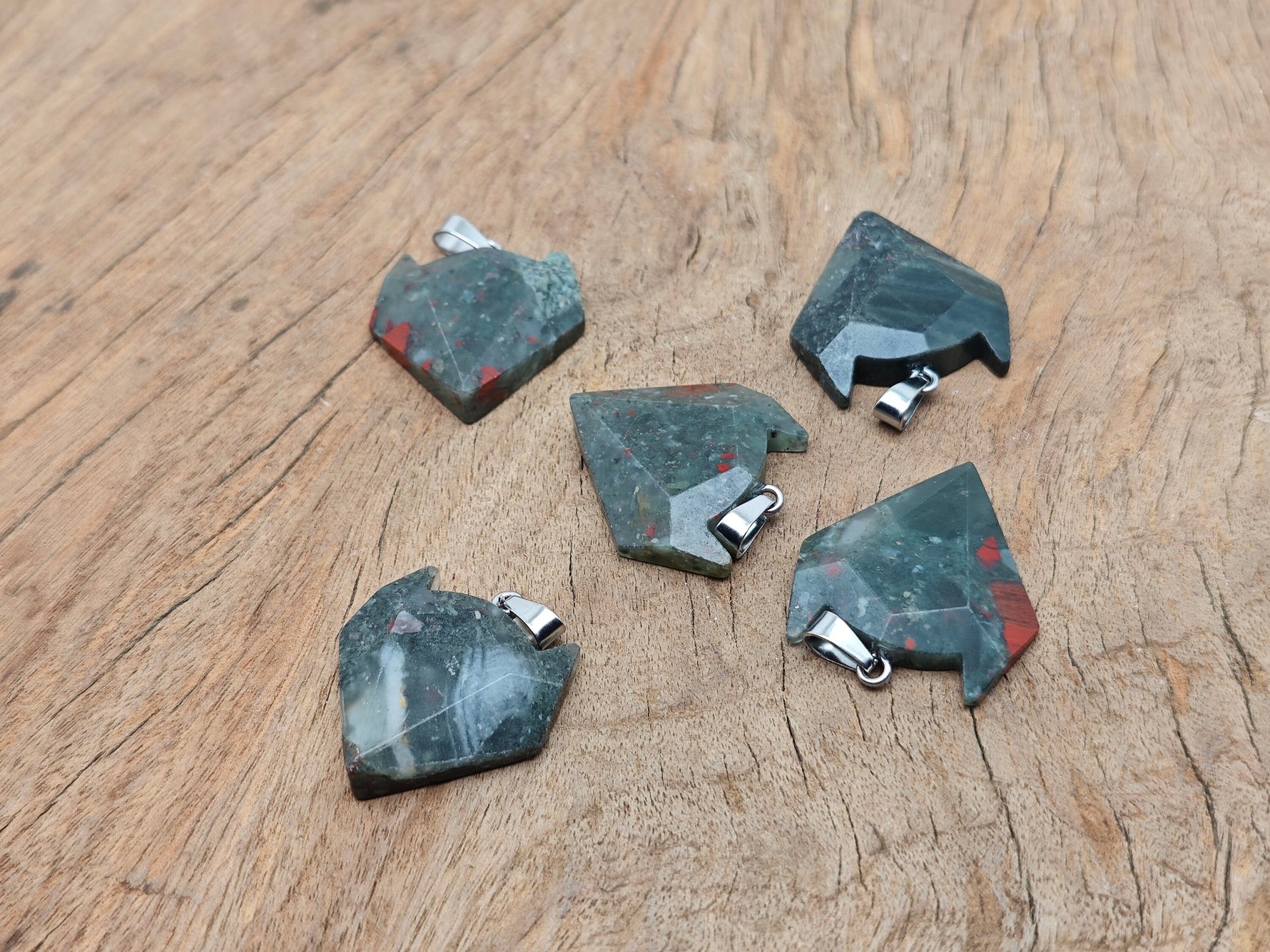 African Bloodstone wolf head gemstone pendant featuring a carved wolf design in vibrant bloodstone, perfect for crystal jewelry enthusiasts.