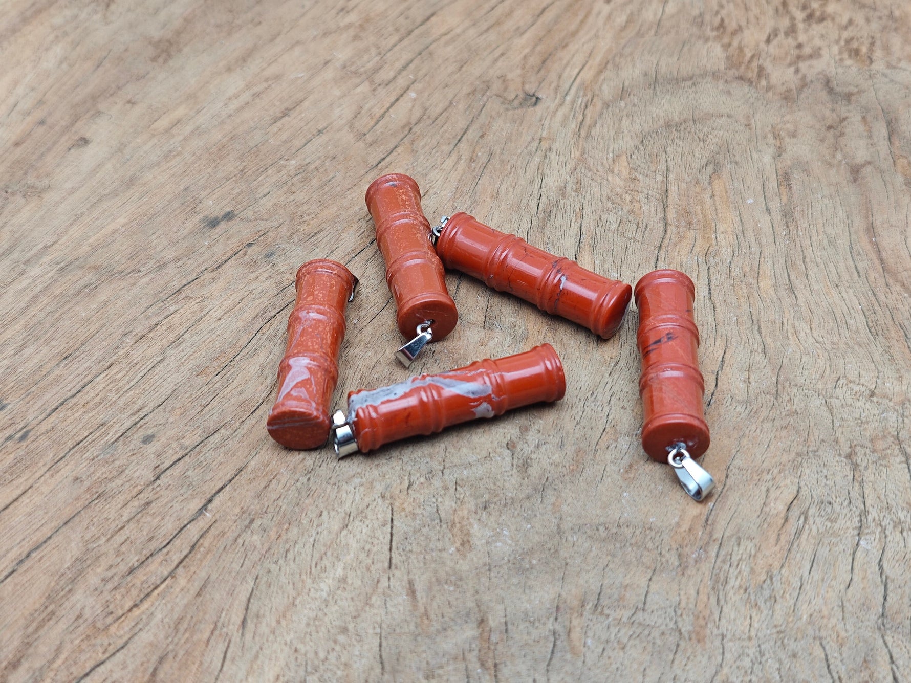 Red Jasper bamboo-shaped crystal pendant by GemstoneGO, featuring a protective red jasper stone on a sleek bamboo design.