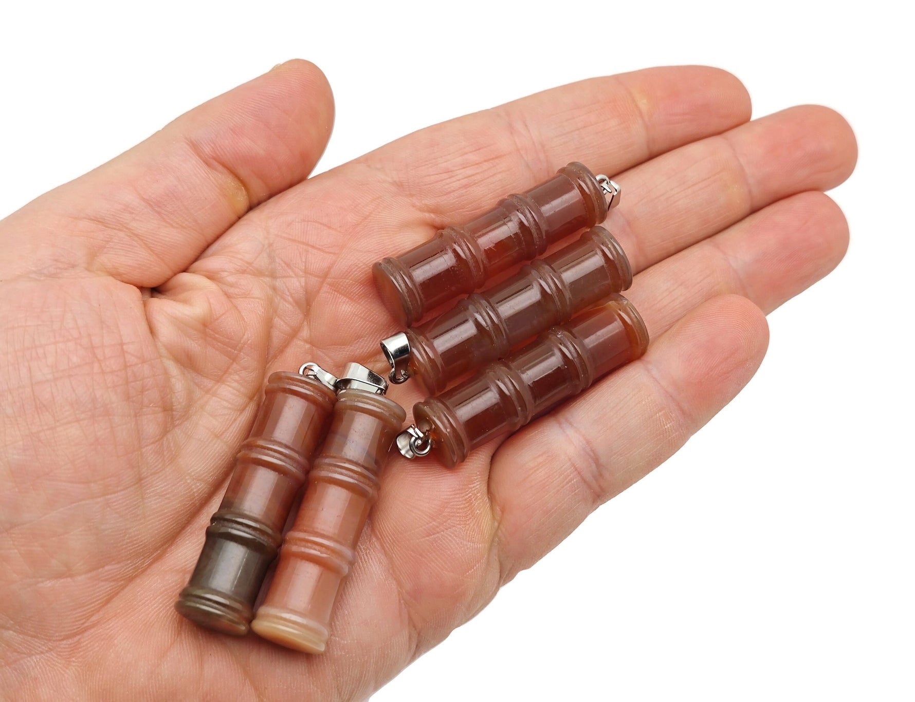 Carnelian bamboo-shaped crystal pendant from GemstoneGO featuring protective crystal design with vibrant orange stone.