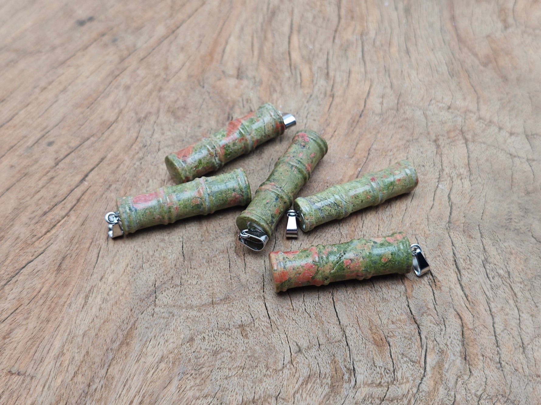 Unakite bamboo shape crystal pendant from GemstoneGO, featuring protective crystal with natural green and pink hues.