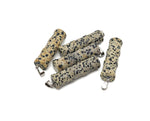 Dalmatian Jasper bamboo-shaped crystal pendant by GemstoneGO featuring a protective crystal design on a silver chain.