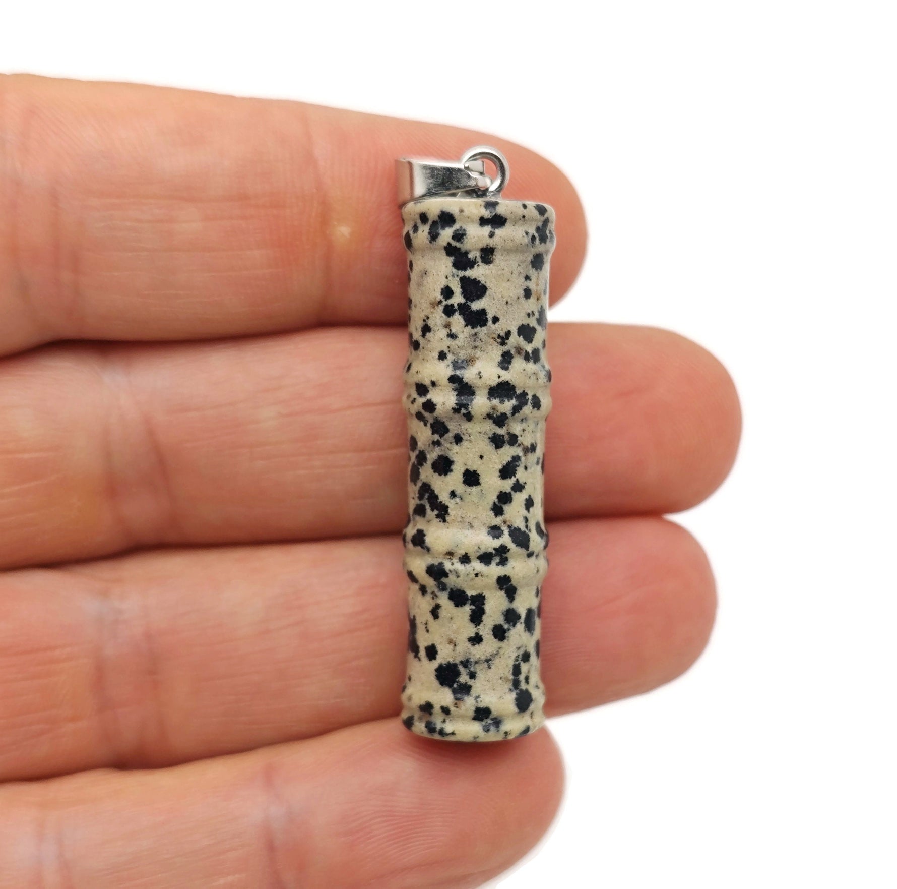 Dalmatian Jasper bamboo-shaped crystal pendant from GemstoneGO, featuring protective crystal with black and white spotted pattern.