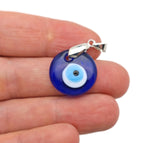 Glass evil eye pendant jewelry by GemstoneGO featuring a blue and white protective evil eye design on a clear glass pendant.