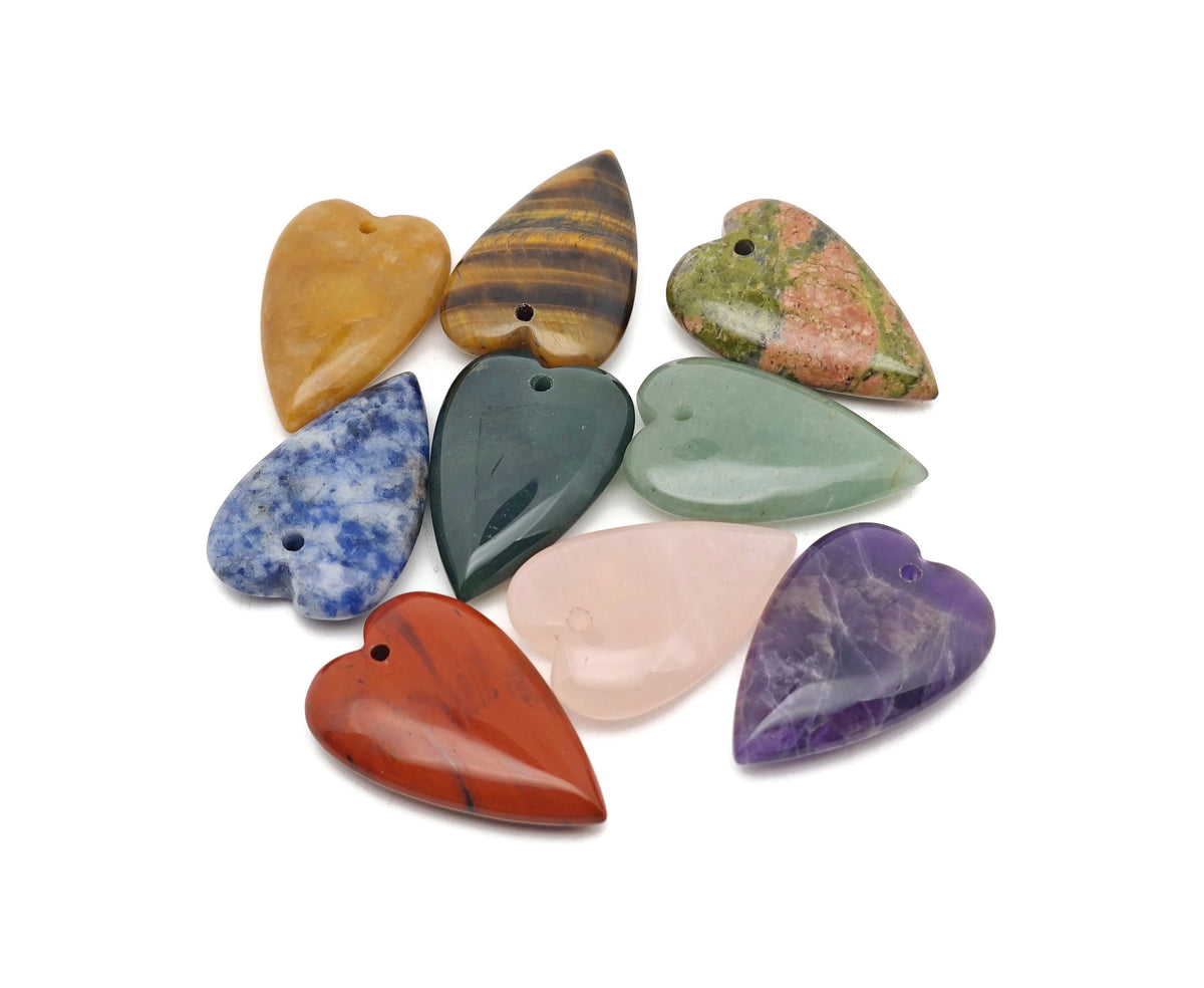 Long heart-shaped gemstone crystal pendant by GemstoneGO featuring a large, sharp, healing heart-shaped crystal in mixed colors.