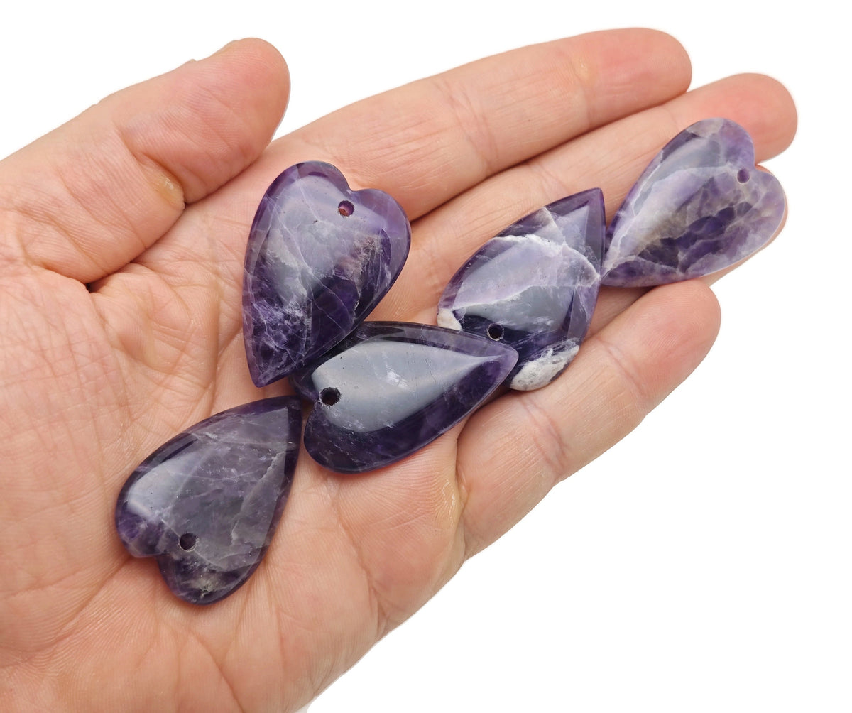 Long heart-shaped love crystal pendant by GemstoneGO featuring a large, sharp gemstone with healing properties.