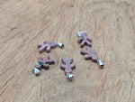Rhodonite gingerbread cookies men crystal pendant from GemstoneGO featuring mineral specimens and intricate detailing.