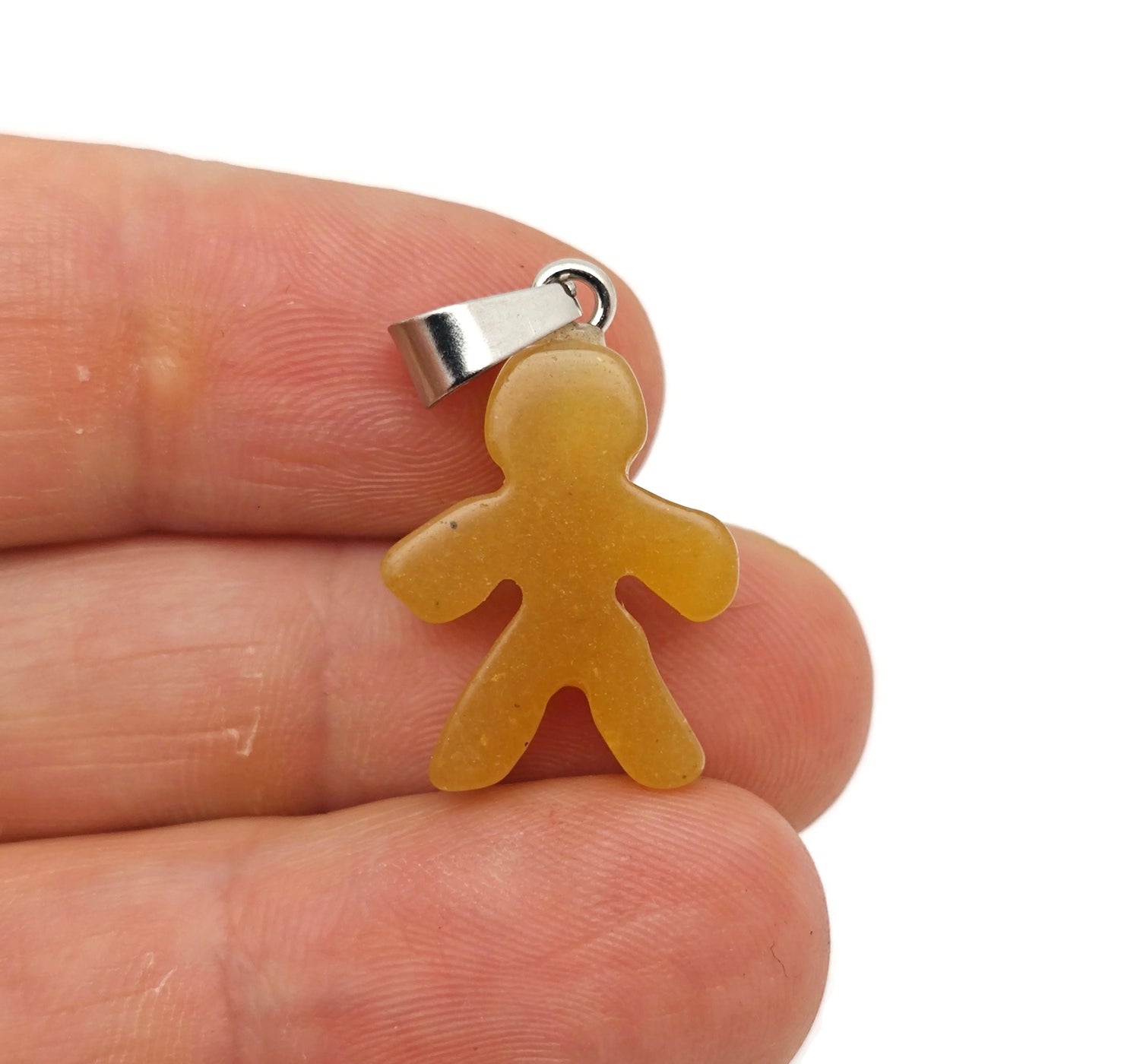 Yellow jade gingerbread men crystal pendant by GemstoneGO featuring a mineral specimen with a detailed gingerbread man shape.