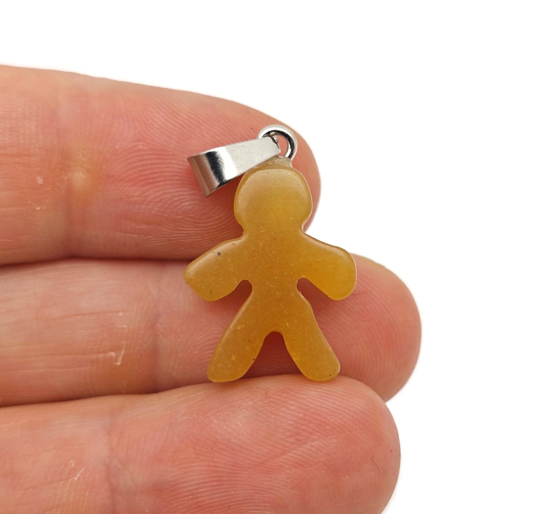 Yellow jade gingerbread men crystal pendant by GemstoneGO featuring a mineral specimen with a detailed gingerbread man shape.