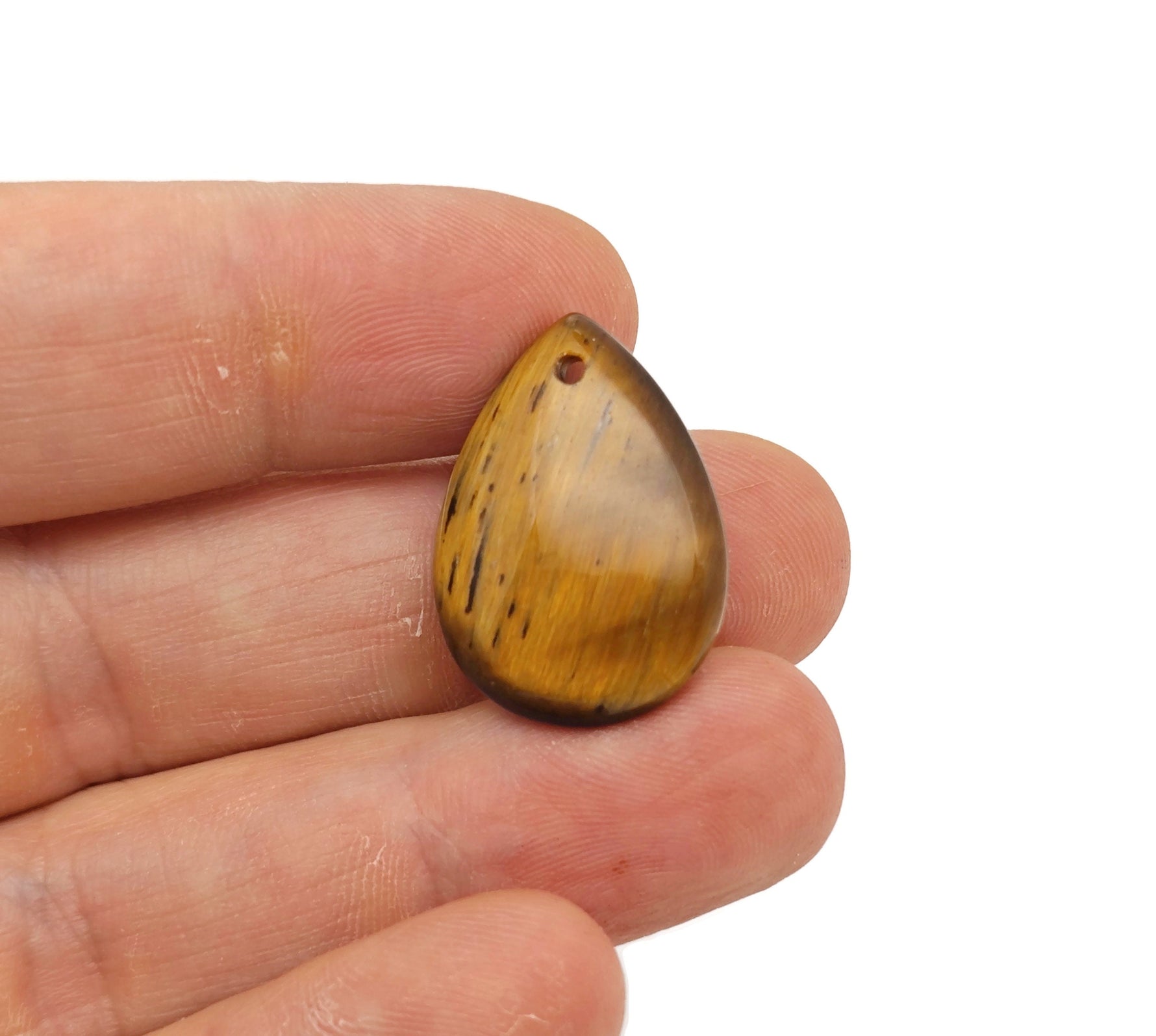 Dainty drop pendant featuring tiger eye gemstone for DIY jewelry making, showcasing a polished crystal with gold-tone findings.