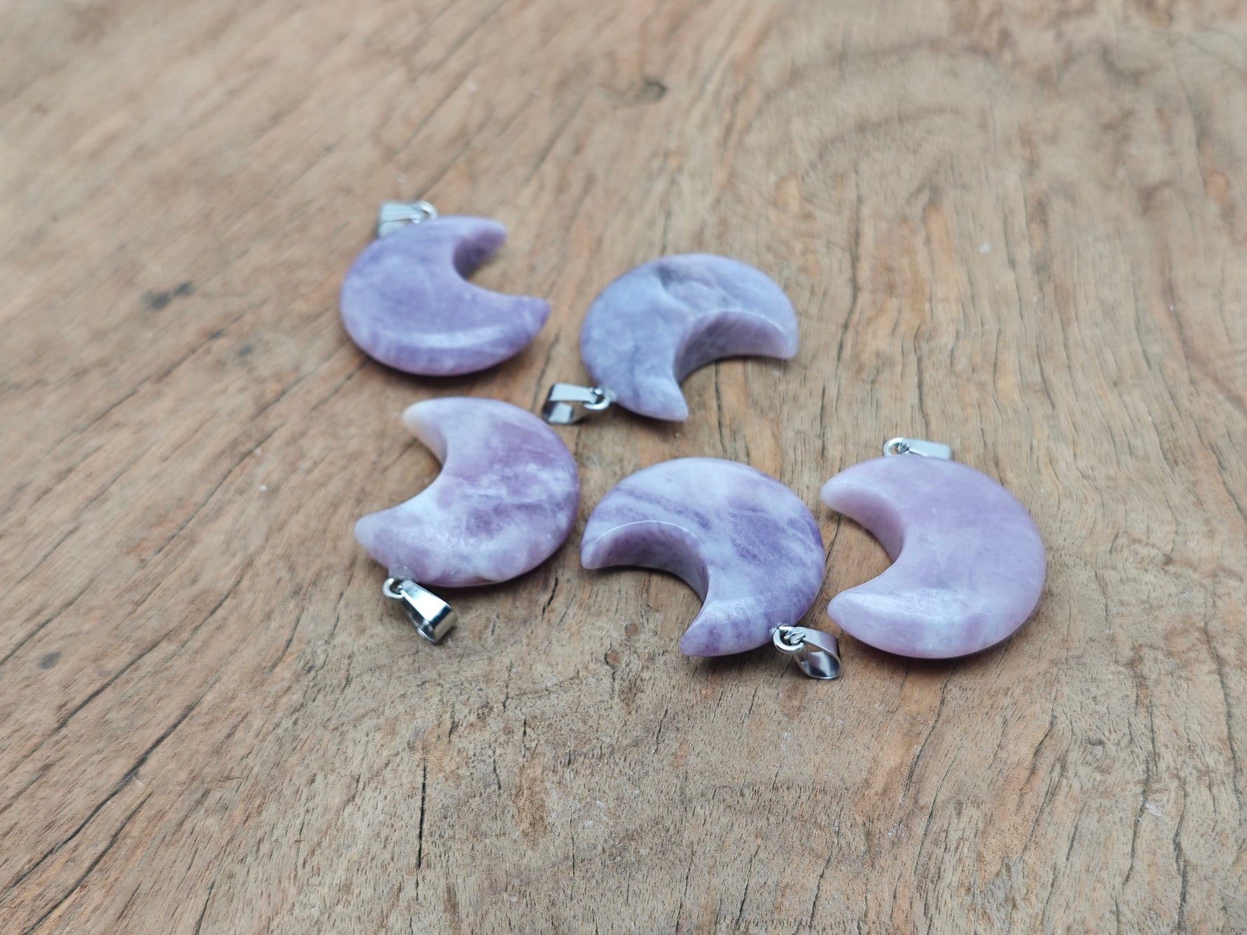 Lepidolite moon gemstone pendant featuring a crescent moon design from GemstoneGO, showcasing purple lepidolite stone and silver setting.