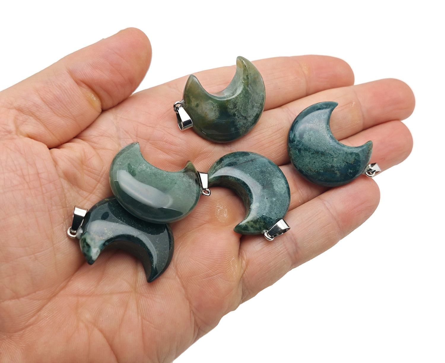 Moss agate gemstone pendant featuring a crescent moon design, showcasing intricate natural patterns and a polished finish.