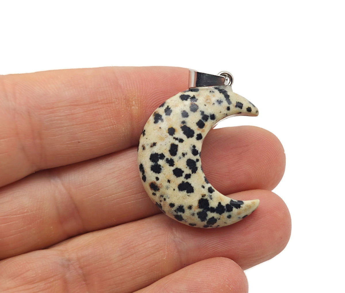 Dalmatian Jasper moon pendant with crescent shape from GemstoneGO, showcasing black and white spotted gemstone on a silver chain.
