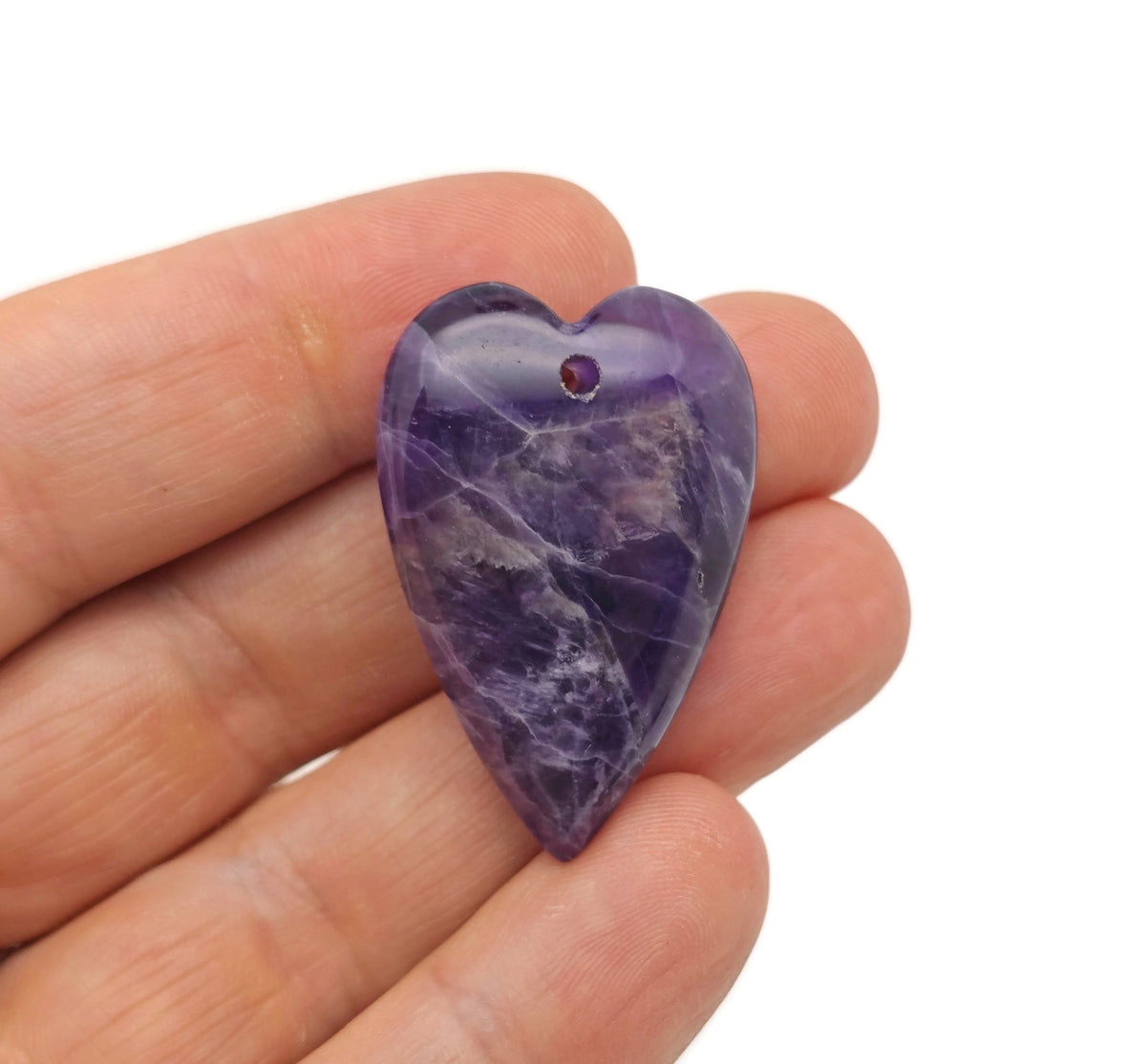 Heart-shaped amethyst pendant with a polished crystal gemstone, featuring a long silver chain and a healing love crystal design.