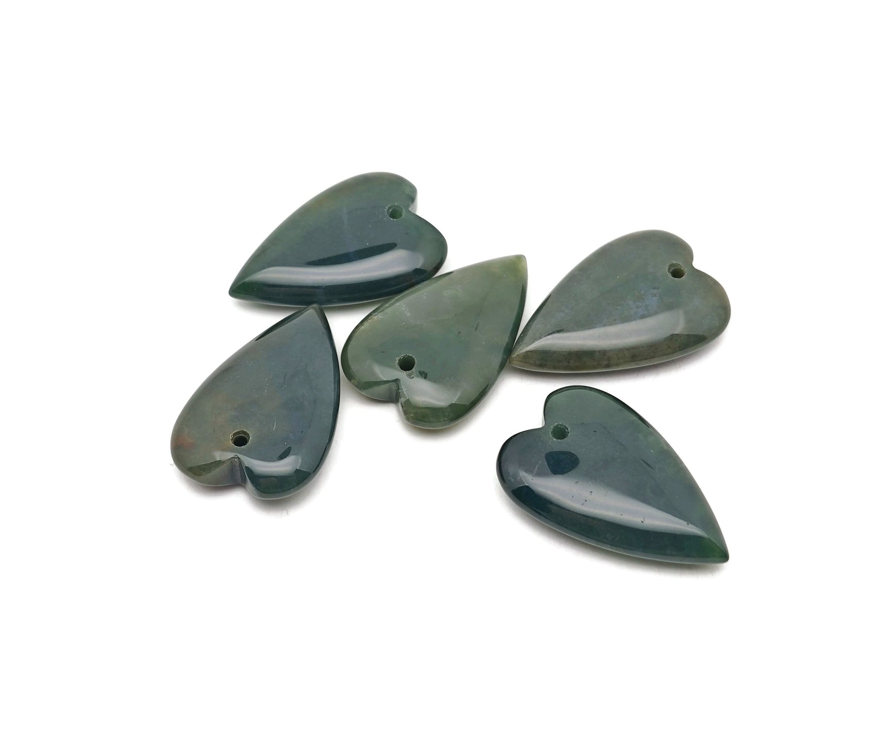 Heart-shaped moss agate pendant with a polished gemstone surface, showcasing natural green and brown earthy patterns.
