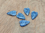 Blue Spot Jasper heart-shaped pendant with a silver bail, showcasing vibrant blue patterns and a polished finish.