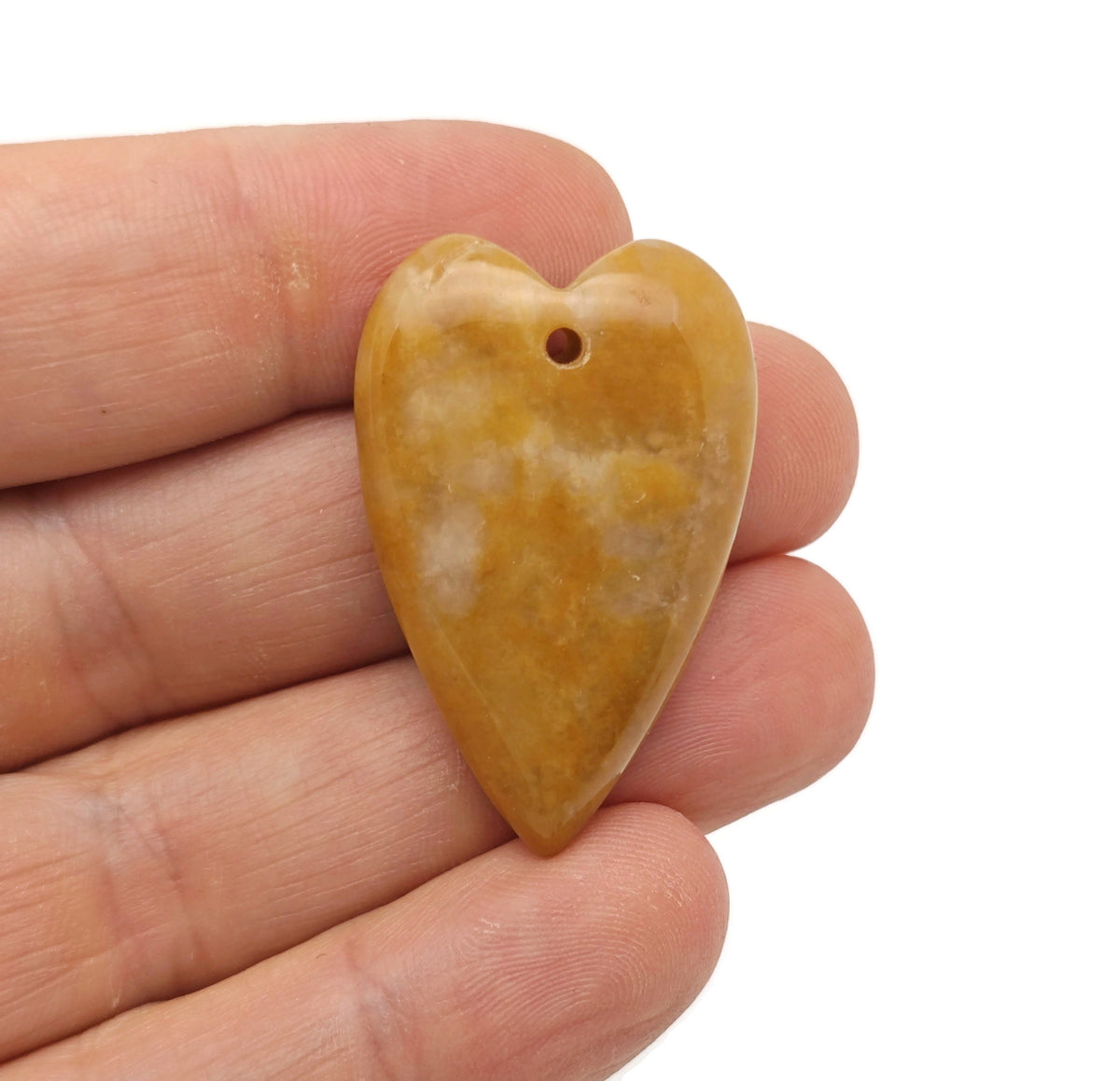 Heart-shaped jade love crystal pendant with healing gemstone, featuring a long, elegant design from GemstoneGO.