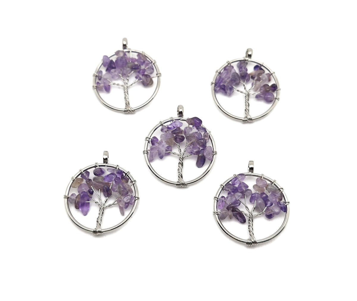 Amethyst Tree of Life gemstone pendant featuring purple amethyst crystals on a silver setting, displayed close-up.