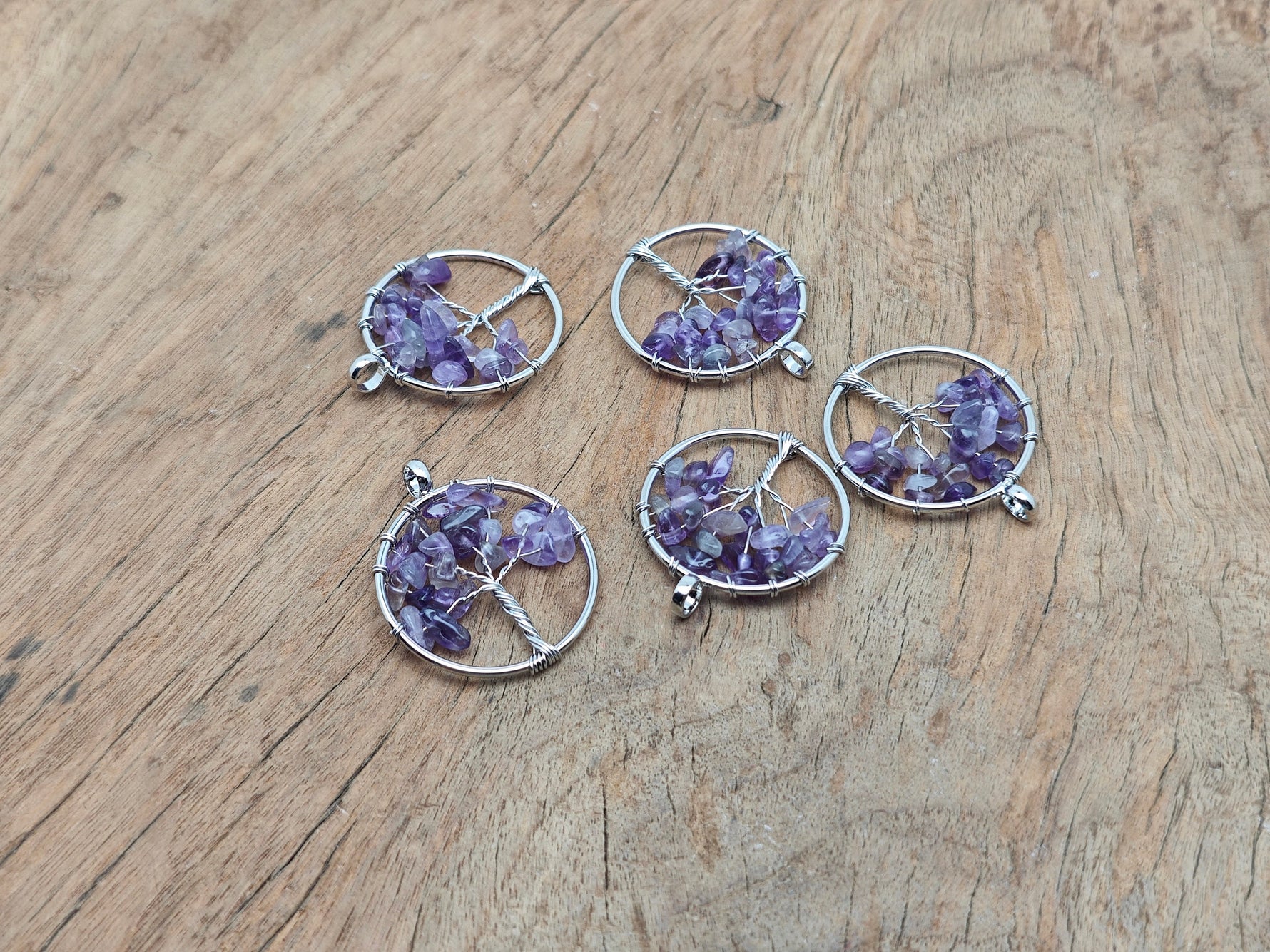Amethyst Tree of Life gemstone pendant with intricate metalwork from GemstoneGO, showcasing a purple amethyst crystal design.