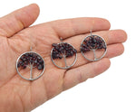 Garnet Tree of Life gemstone pendant from GemstoneGO featuring intricate wire wrapping and a vibrant red garnet stone.