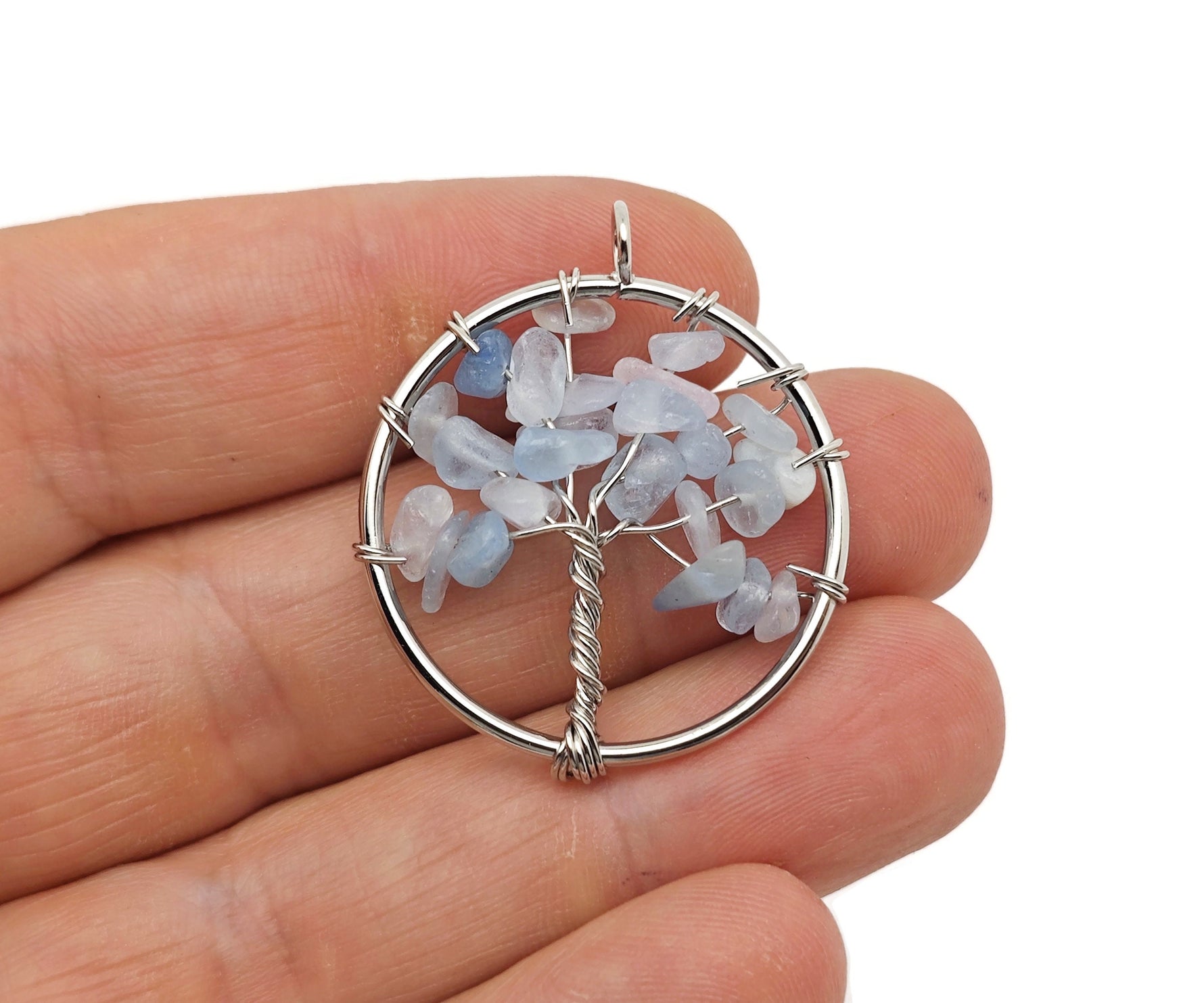 Aquamarine Tree of Life gemstone pendant from GemstoneGO featuring intricate wire wrapping and vibrant aquamarine crystals.