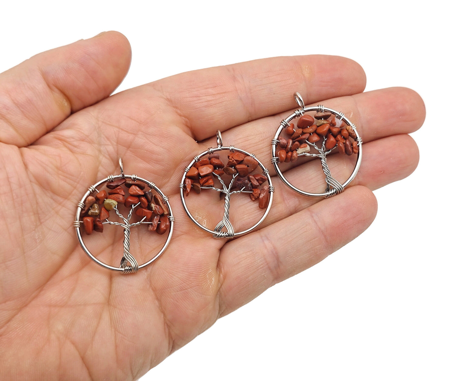 Red Jasper Tree of Life gemstone pendant from GemstoneGO featuring a detailed crystal tree design on a polished red jasper background.