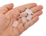 Rose quartz rectangle crystal pendant from GemstoneGO, showcasing a polished pink gemstone with a silver bail on a plain background.