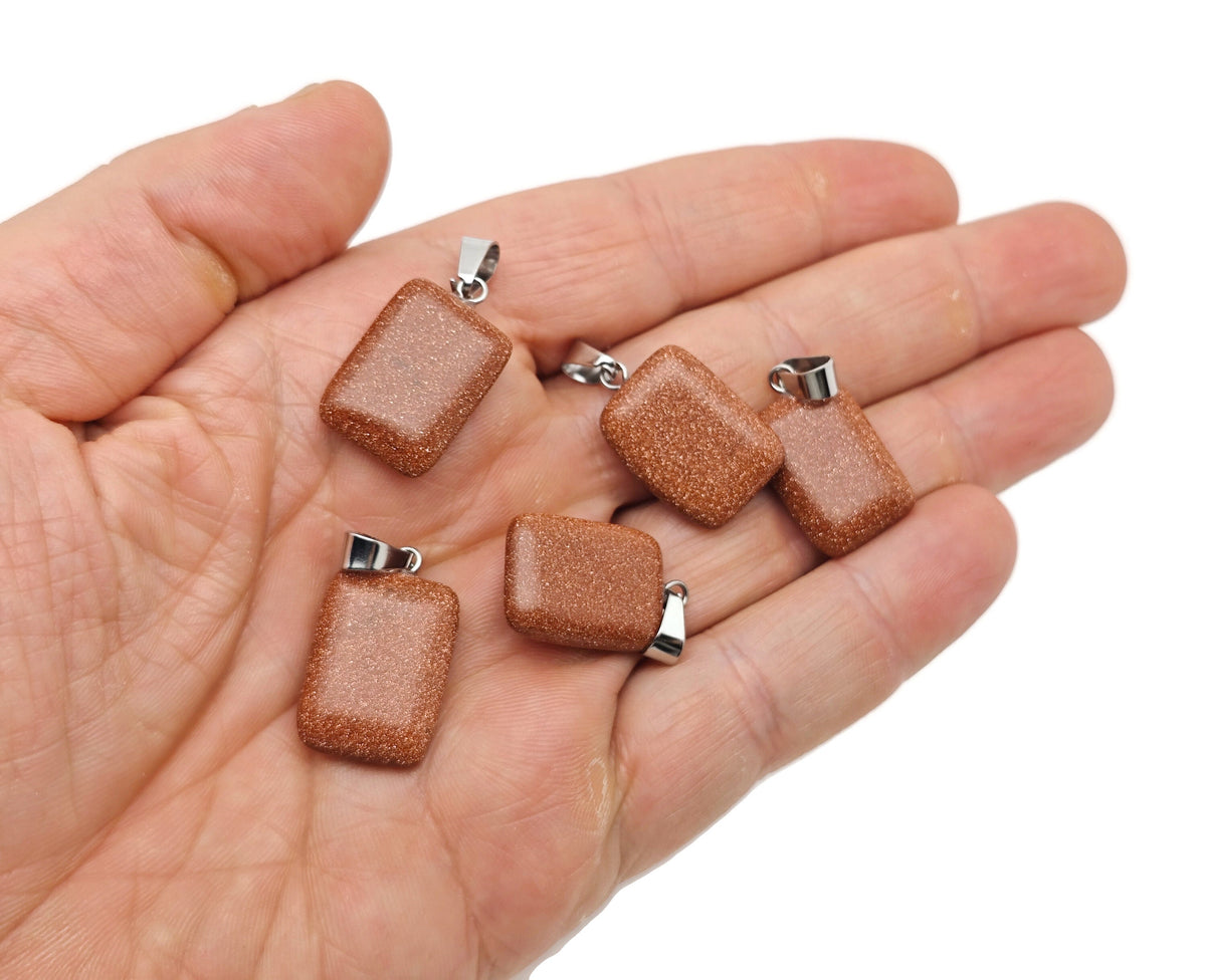 Goldstone rectangle-shaped crystal pendant from GemstoneGO, showcasing a polished goldstone gemstone with a smooth rectangular design.