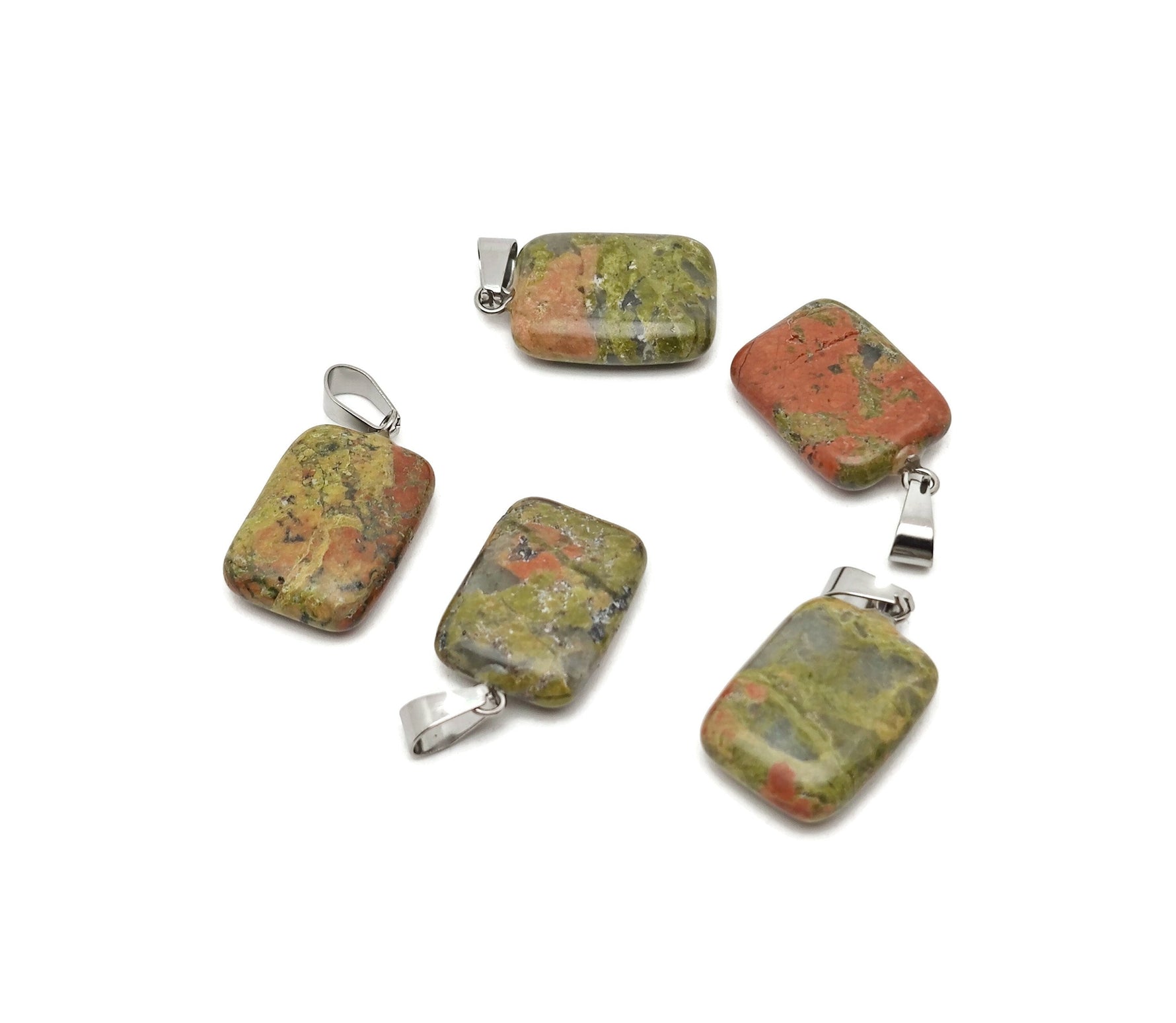 Unakite rectangle crystal pendant from GemstoneGO, showcasing a vibrant green and pink gemstone with silver bail on a plain background.