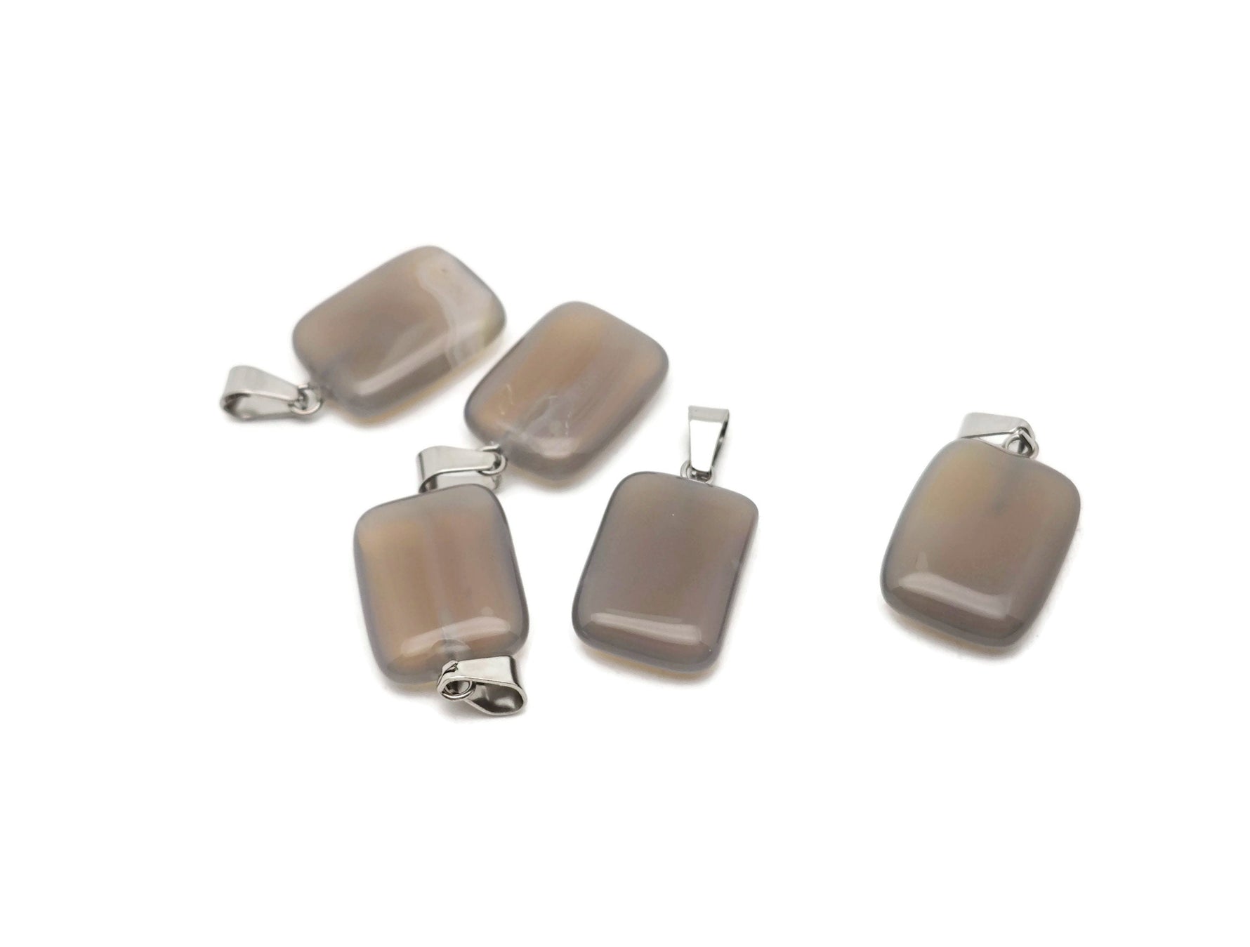 Gray agate crystal pendant in rectangular shape from GemstoneGO, showcasing a polished gemstone with natural banding and smooth surface.