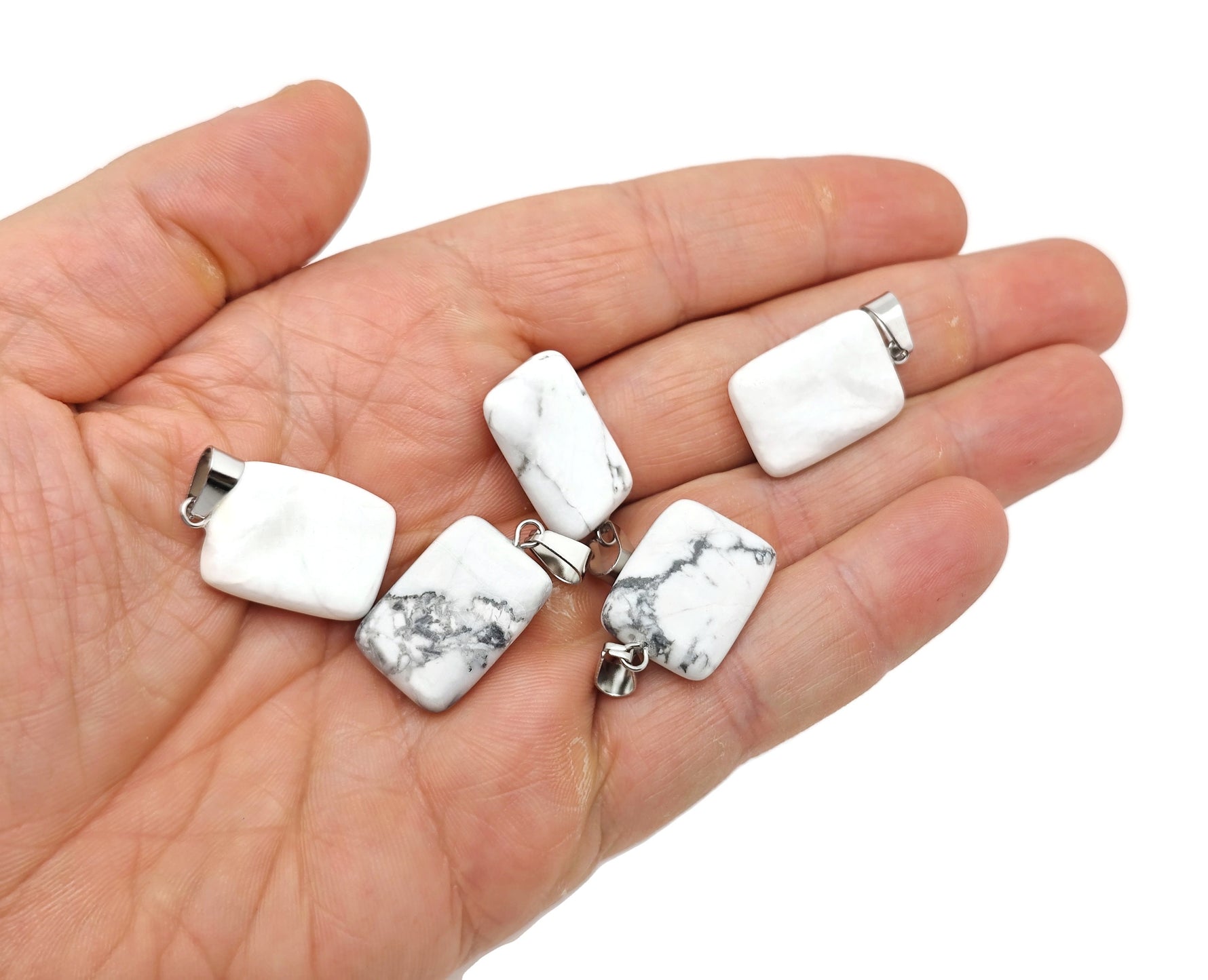 Howlite rectangle-shaped crystal pendant by GemstoneGO, showcasing smooth white gemstone with gray veining on a jewelry chain.