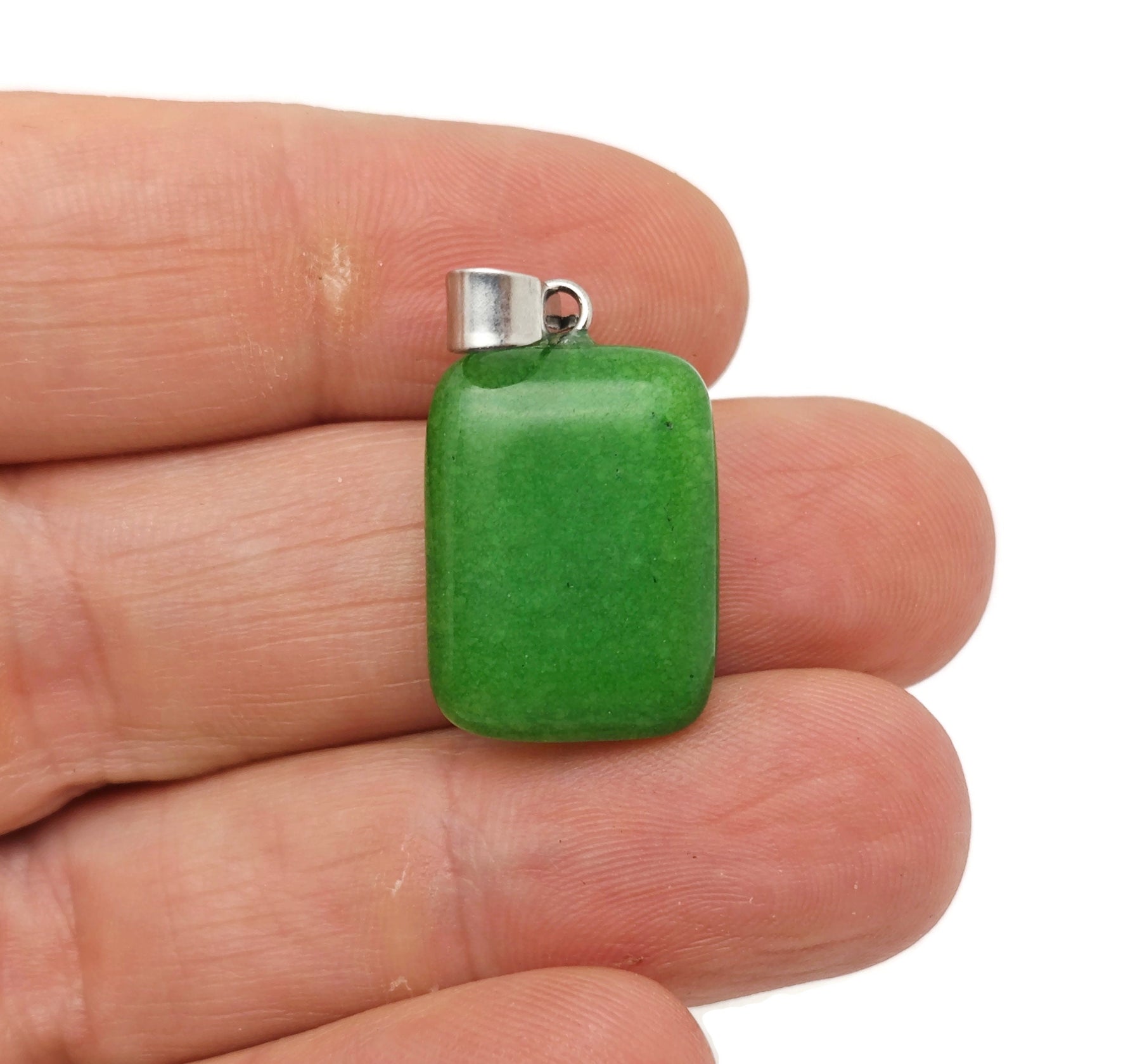 Green agate rectangle crystal pendant from GemstoneGO showcasing a polished rectangular gemstone with natural green patterns.