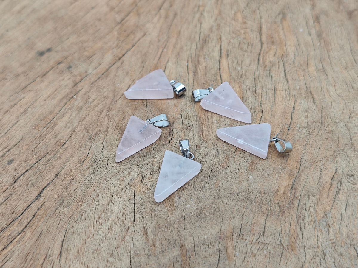 Rose quartz triangle crystal pendant from GemstoneGO, showcasing a smooth, polished pink gemstone in a triangle shape.