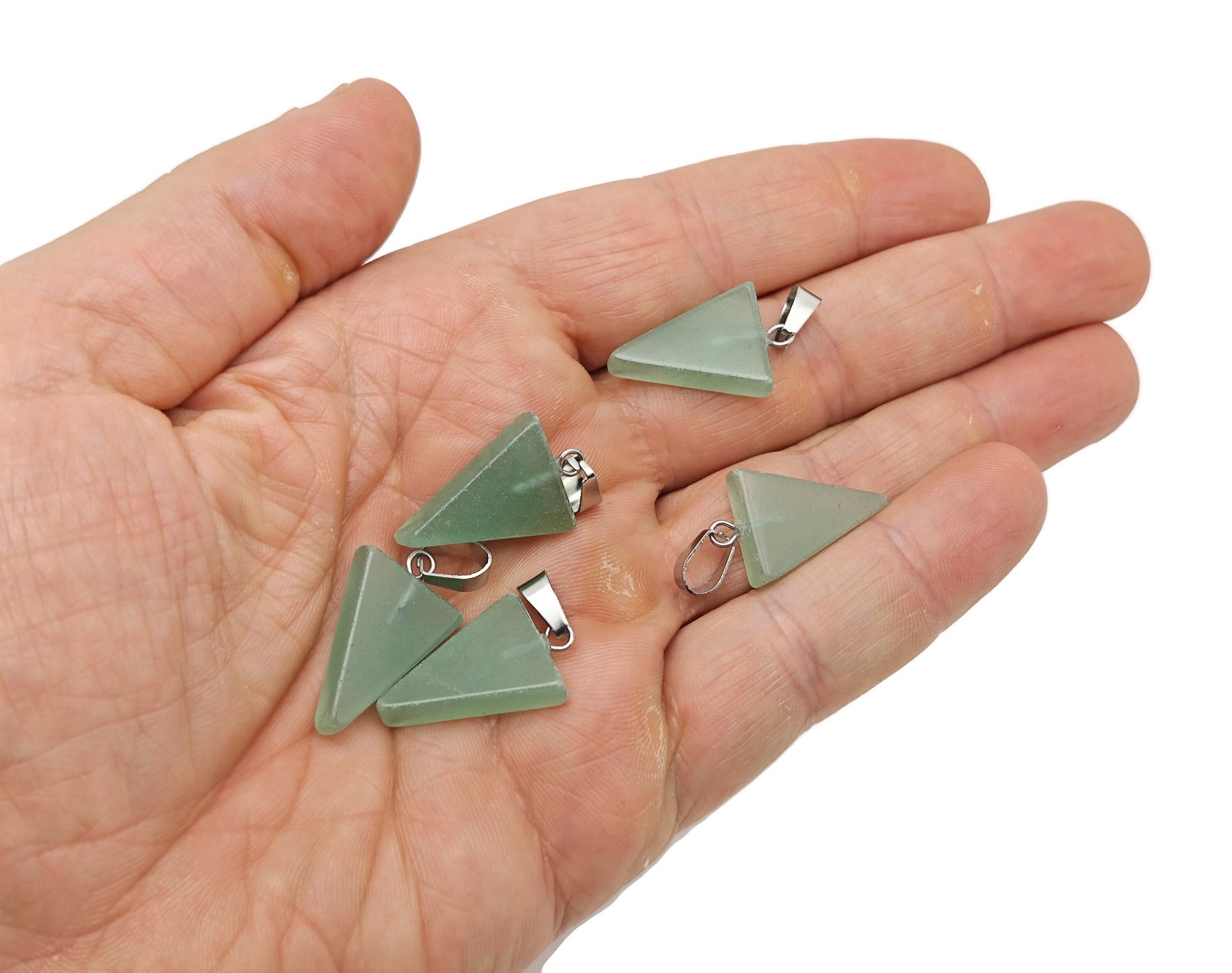 A green aventurine triangle-shaped crystal pendant from GemstoneGO, showing the polished, faceted gemstone on a plain background.
