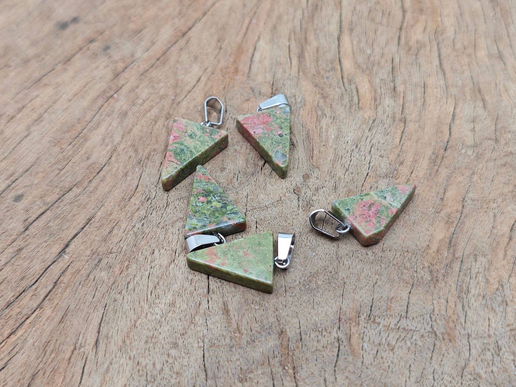 Unakite triangle-shaped crystal pendant by GemstoneGO, showcasing vibrant green and pink hues in a smooth, polished gemstone.