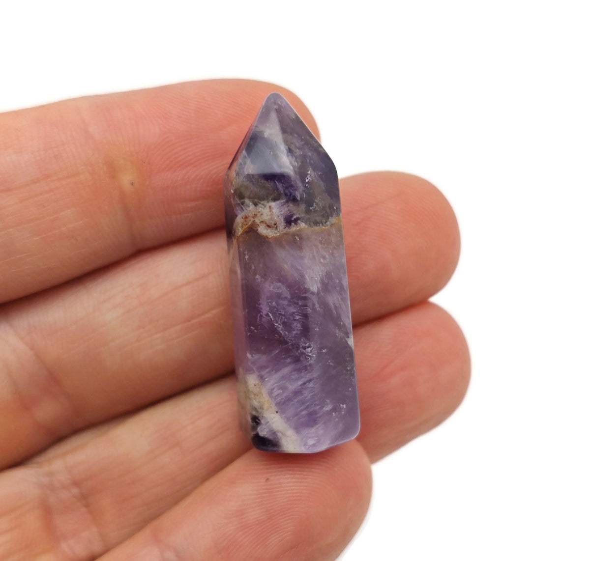 Amethyst obelisk tower crystal from GemstoneGO, 40mm, showcasing purple hues and polished faceted surface.