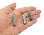 A 40mm green aventurine obelisk tower crystal from GemstoneGO, polished stone with natural stone patterns and pointed top.