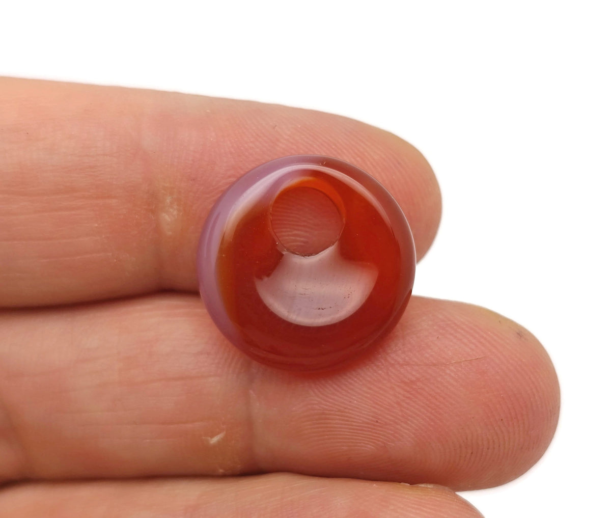 Carnelian crystal donut pendant, 18mm Pi Stone from GemstoneGO, showcasing vibrant orange-red polished gemstone with smooth, rounded shape.