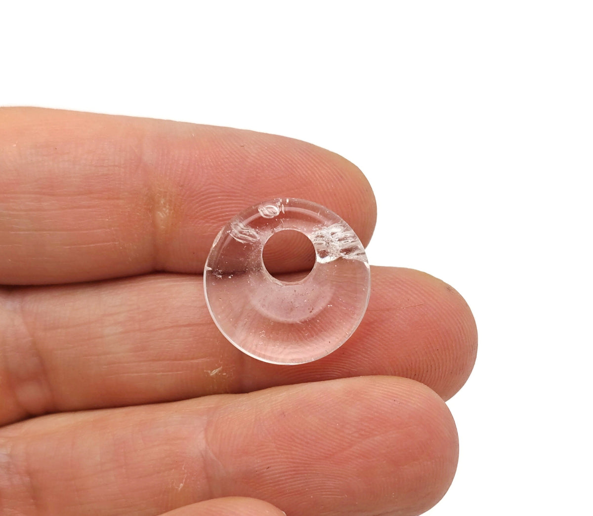 Clear quartz crystal donut pendant from GemstoneGO, 18mm Pi stone with a smooth, polished surface and circular shape.