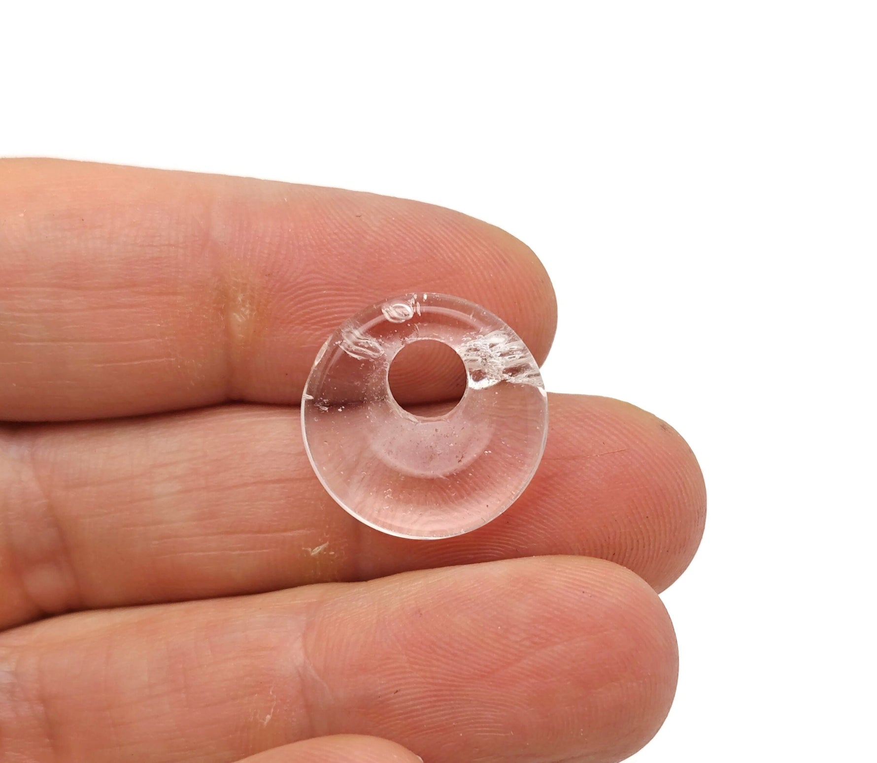 Clear quartz crystal donut pendant from GemstoneGO, 18mm Pi stone with a smooth, polished surface and circular shape.