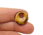 Polished 18mm Tiger Eye crystal donut, Pi stone from GemstoneGO, showcasing its golden-brown banded pattern and smooth round shape.