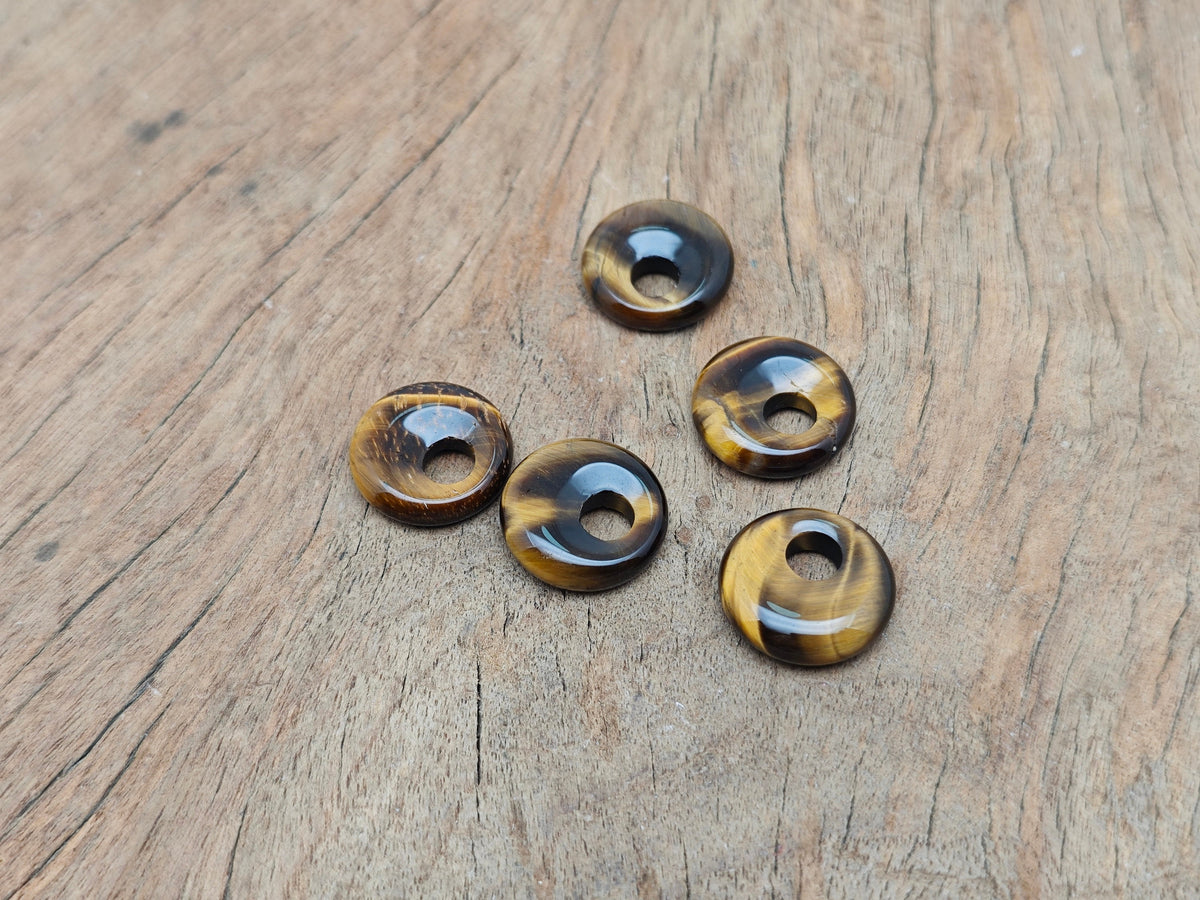 Tiger Eye crystal donut pendant, 18mm Pi stone from GemstoneGO, showcasing the polished, rounded gemstone with rich golden-brown hues.